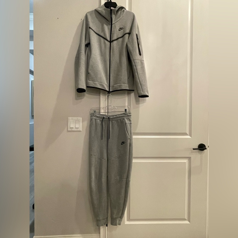 Grey Nike Tech. Jacket Size: Men’s Small. Pants Size: Men’s Small.